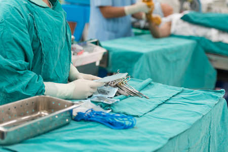 Scrub nurse preparing tools for operation