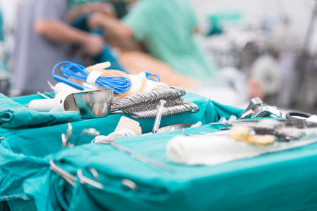 Scrub nurse preparing tools for operation