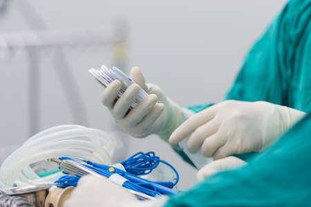 scrub nurse preparing tools for operation