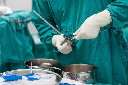 scrub nurse preparing tools for operationの写真素材