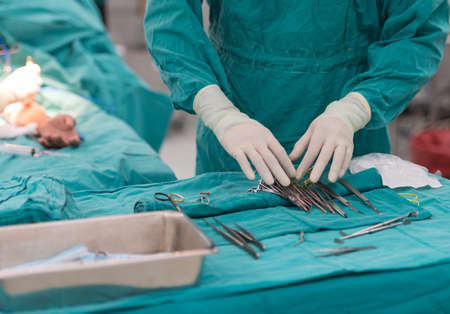 scrub nurse preparing tools for operation