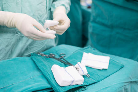 Scrub nurse prepare medical instruments for surgeryの写真素材