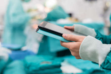 surgeon using digital tablet in operation roomの写真素材