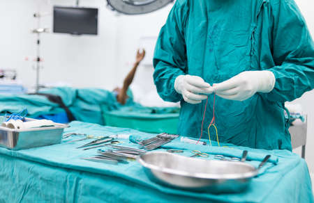 scrub nurse preparing medical instruments for operationの写真素材