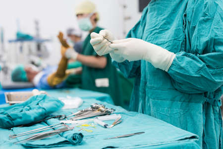 scrub nurse preparing medical instruments for operationの写真素材