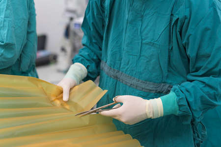 scrub nurse preparing medical instruments for operationの写真素材