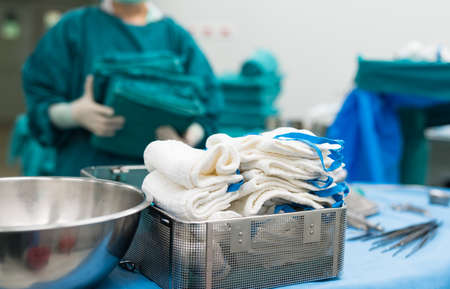 scrub nurse preparing medical instruments for operationの写真素材