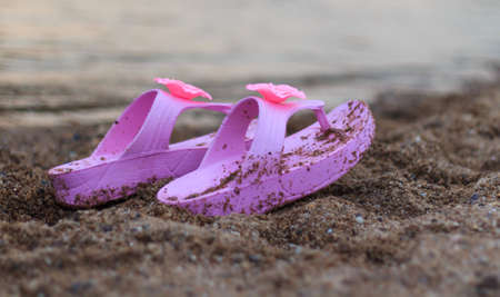 pink shoes on sand beach in thailandの写真素材