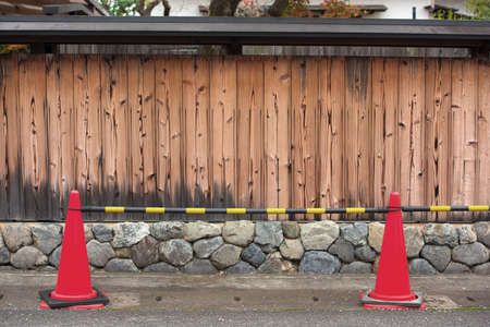 Traffic cones and wooden fenceの写真素材