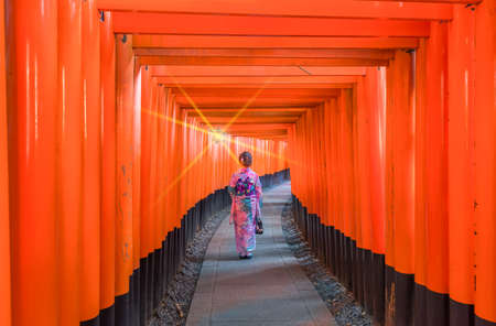 Women in kimono stand at Red Torii gates in Fushimi inari,Japanのeditorial素材