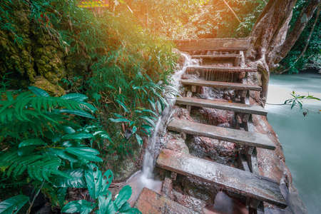 Waterfall on wooden stairs at Kanchanaburi province,Thailandの写真素材