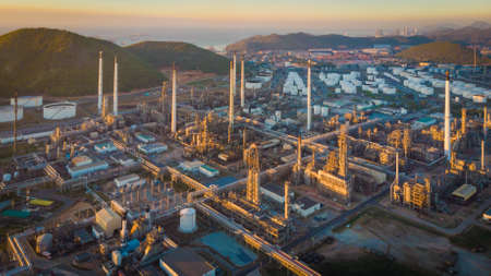 Aerial view Oil refinery with a background of mountains and seaの写真素材