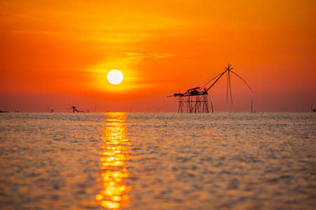 Beautiful sunrise at Pakpra canal,Scenic view of Pakpra early in the beautiful morning. vintage bamboo fish trap machineの写真素材