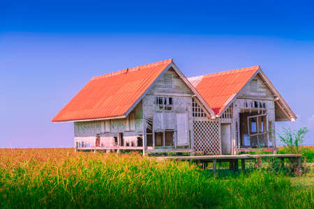 Dilapidated of landmark twin house at Talaynoi with blue sky, Chaloem Phrakiat Bridge, Phattalung in Thailandの写真素材