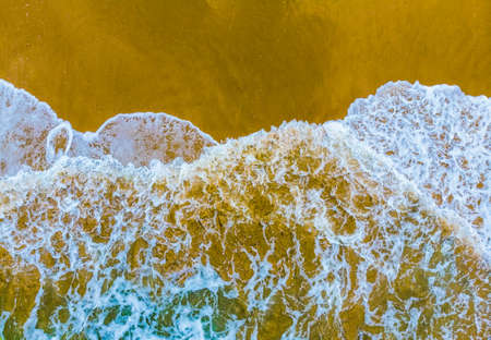 Aerial shot of the couple on the sand beach in Thailandの写真素材