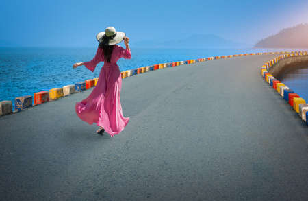  Asian woman wearing a dress walking on the streets with colorful sidewalksの写真素材
