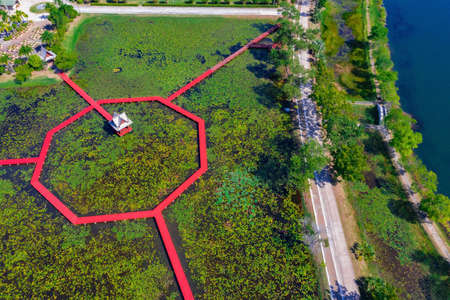 Red wooden bridge at Park in Chiang Khruea,Lotus Park at Sakon Nakhon, Thailand.の写真素材