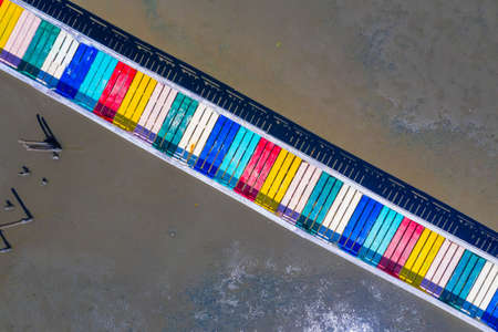 Rainbow bridge in Thailand.View of The colorful wood bridge extends into the sea at samut sakhon province,Thailand,Aerial viewの写真素材