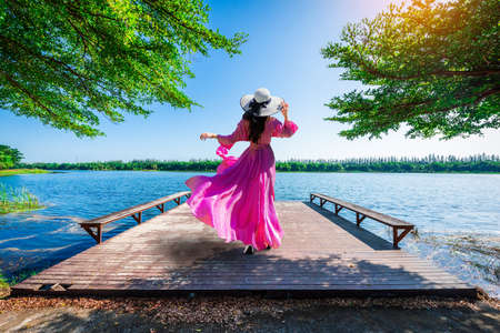 Young tourist stands on Nong Han Pier. Near the lotus garden in Sakon Nakhon Province,Thailandの写真素材