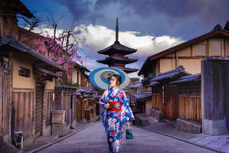 Asian woman walking Yasaka in street near Pagoda in Kyoto, Japanの写真素材