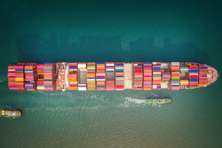 Container ship in export and import business and logistics. Aerial view