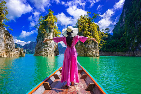 Asian woman standing on boat in Ratchaprapha dam Khao sok national park at Suratthani,Thailandの写真素材