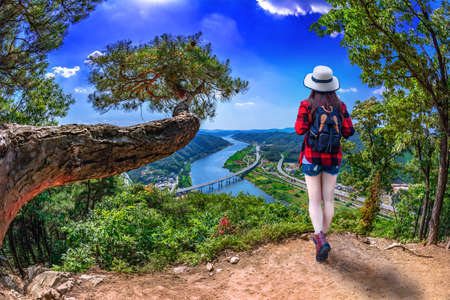 Asian women standing on the observation deck With the river as the line of sight at Kongju, South Koreaの写真素材