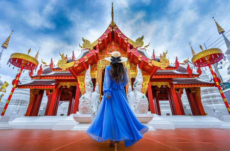 Asian female tourist wearing a blue dress visits Khuakrae Temple in Chiang Rai, Thailandの写真素材