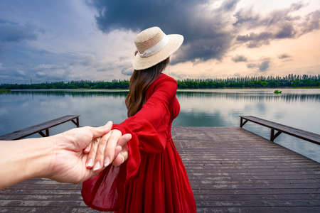 Thai women tourists Holding the hand of a lover to visit Nong Han in Sakon Nakhon Province, Thailandの写真素材
