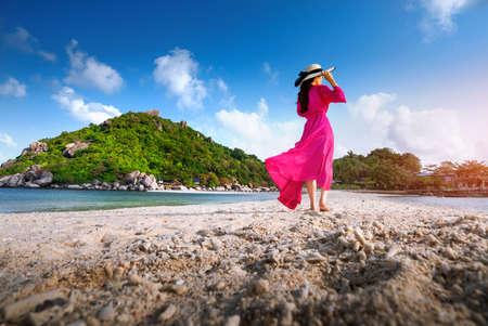 Asian woman walking on the beach of separated sea on the island of Koh nangyuan in Thailandの写真素材
