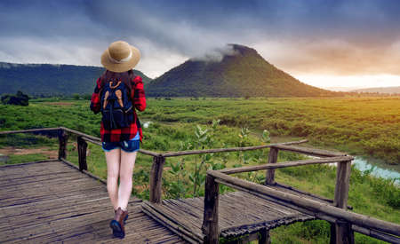 Young Asian tourists stand on the viewpoint overlooking beautiful viewの写真素材