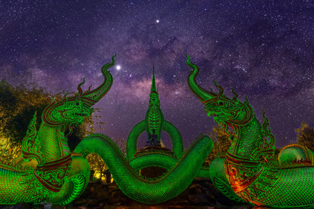 A glowing serpent statue with milky way at Wat Pa Phupang temple Si Chiang Mai District, Ubon Ratchathani Province, Thailandの写真素材