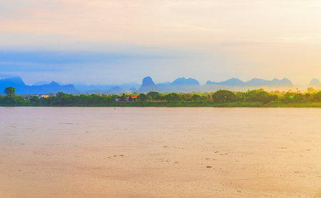 fast-moving clouds over the Mekong River, the border between Thailand and Laosの写真素材