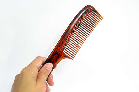 Hand holding a comb