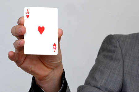 Businessman showing ace