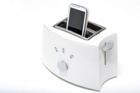 Mobile phone in the toasterの写真素材