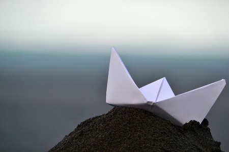Paper boat on sandの写真素材