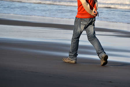 Man walking on the beachの写真素材