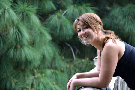 Young woman resting on a bridgeの写真素材
