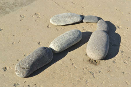 Row by stones in the form of an arrowの写真素材