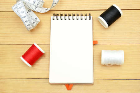 thread, notebook and tape measureの写真素材
