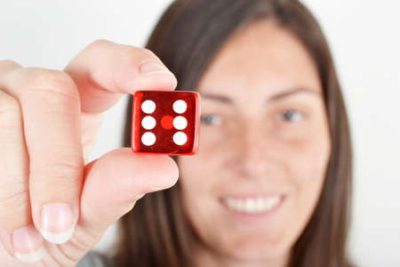 young woman showing a diceの写真素材
