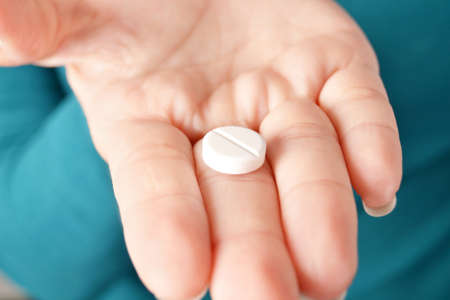 Person showing a pill