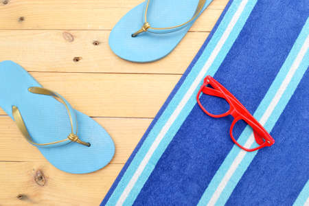 Towel, glasses and beach slippersの写真素材