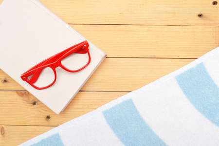 Book, glasses and beach towelの写真素材