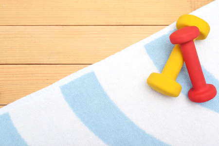 Dumbbells on the beach towelの写真素材