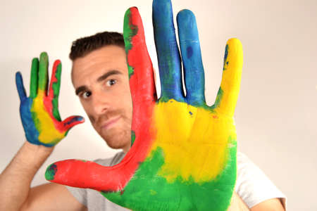 Man looking into the camera with painted handsの写真素材