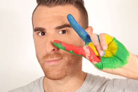 Man making victory gesture with hand paintedの写真素材