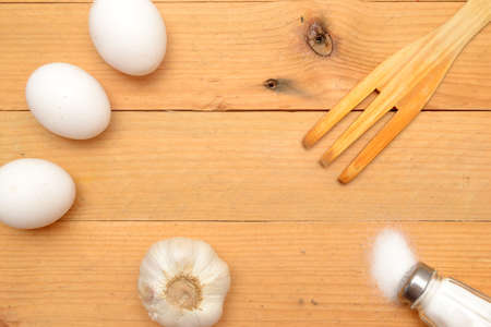Hat cooking, eggs, wooden fork and salt