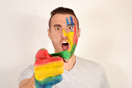 Young man with hand and face paintedの写真素材